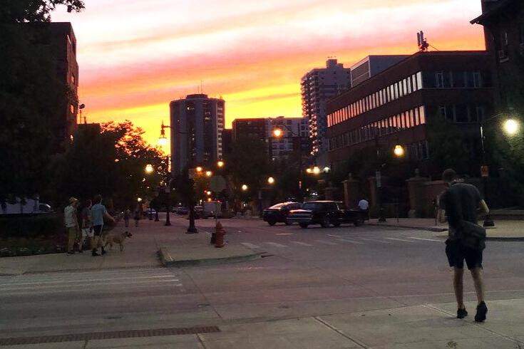 student walking on campus at sunset