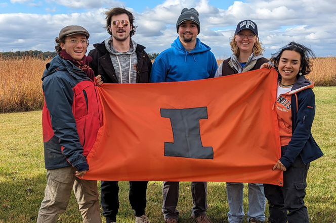 2023 Illinois Soil Judging Team holding a flag with a block I