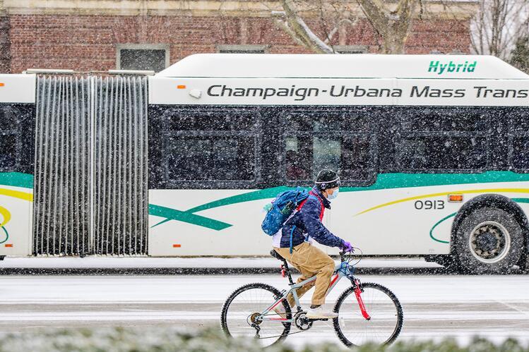 Student on bicycle and MTD bus