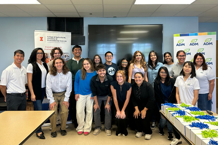 A group of people posting for a photo in a classroom setting