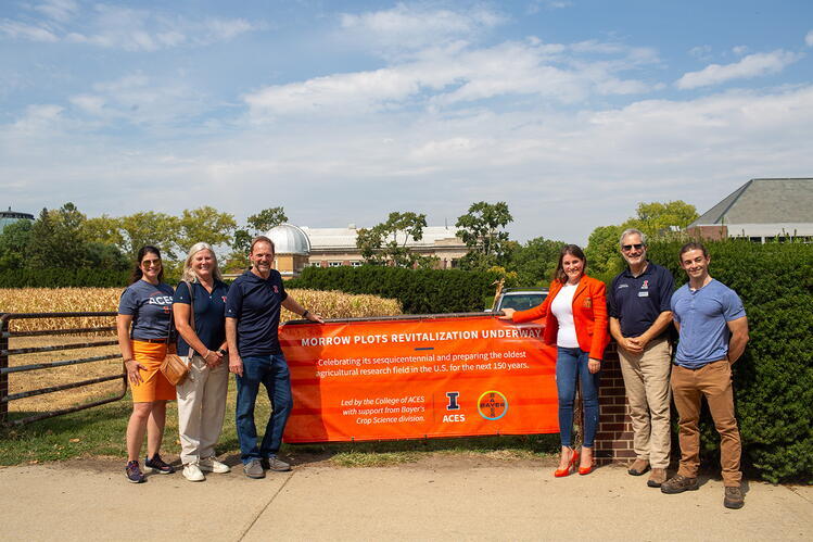 University of Illinois leaders and partners from Bayer celebrate the launch of the Morrow Plots Revitalization project. The effort honors the sesquicentennial of the nation’s oldest agricultural research field and prepares it for the next 150 years of discovery. A group of six people stand outdoors in front of the Morrow Plots