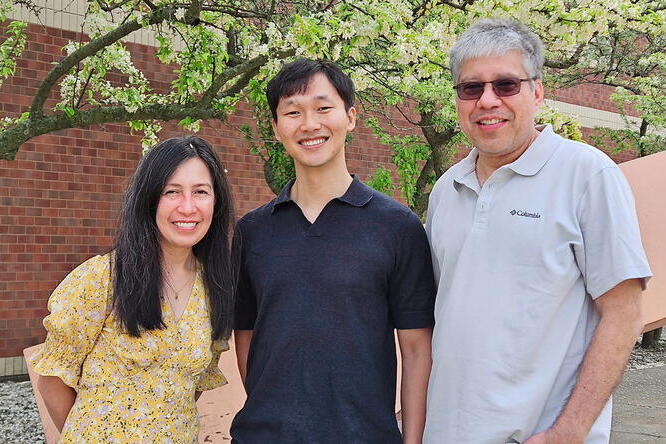 From left: Maria Chu, Jeongho Han, and Jorge Guzman Three individuals standing outside in front of a building and a blooming tree