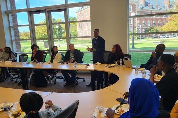 Counselor White speaks to students in the ACES Library. 