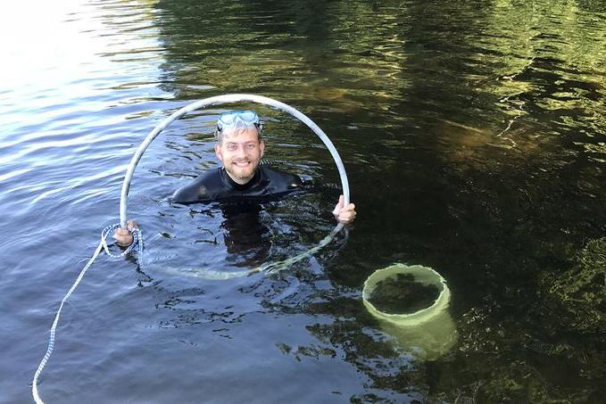 Danny Szydlowski sampling for aquatic snails