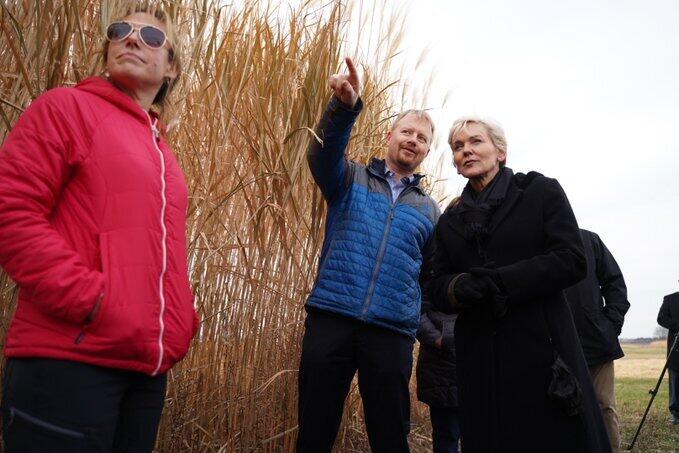 U.S. Secretary of Energy Jennifer Granholm, right, visits CABBI fields at the Illinois Energy Farm with Center Director Andrew Leakey and Feedstock Production Theme Leader Emily Heaton.