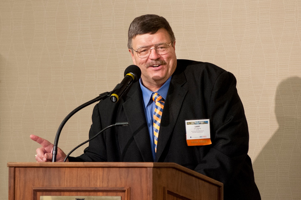 Photo of Larry Hageman speaking at a podium. 