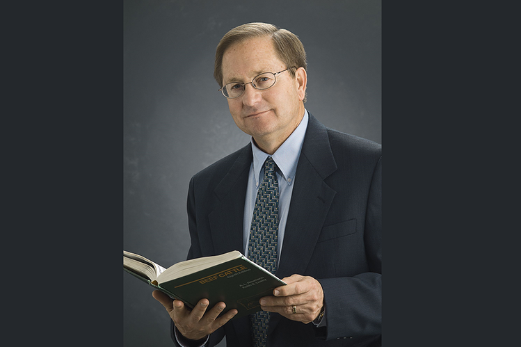 Doug Parrett holds a book.