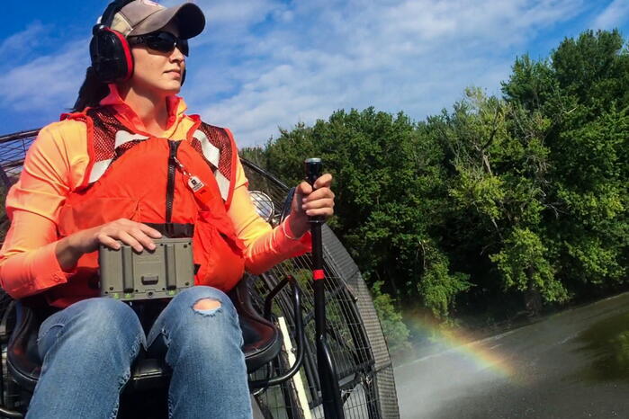 Elizabeth Bruns driving an airboat.