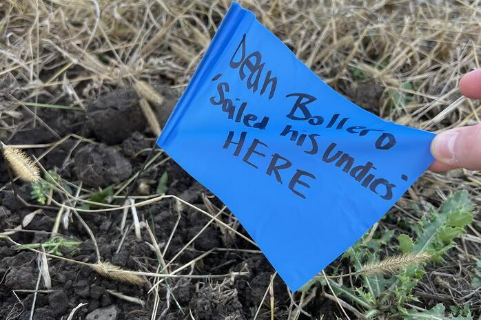 A blue marker flag reads “Dean Bollero soiled his undies HERE"