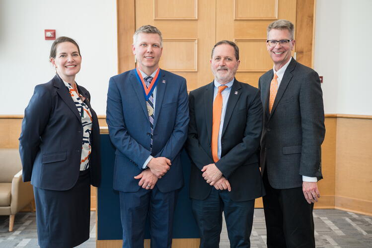 Four people in business attire 