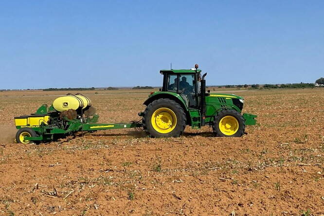 The Data-Intensive Farm Management Project runs field experiments around the world, including a soybean seeding rate trial in the North West Province of South Africa. A tractor drives across a field in South Africa