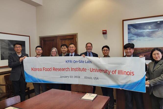 group holding banner that celebrates partnership