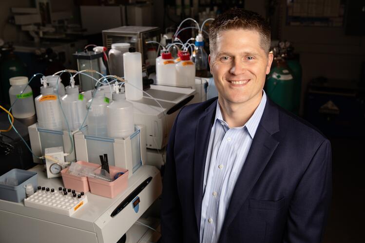 Kelly Swanson standing near lab equipment