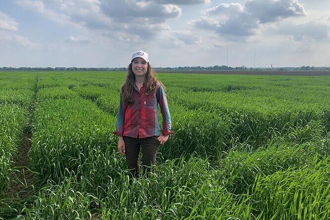Jessica Rutkoski standing in a field of wheat