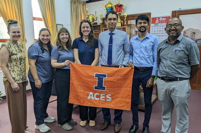 ACES team with Peradeniya administration during site visit. people with ACES flag