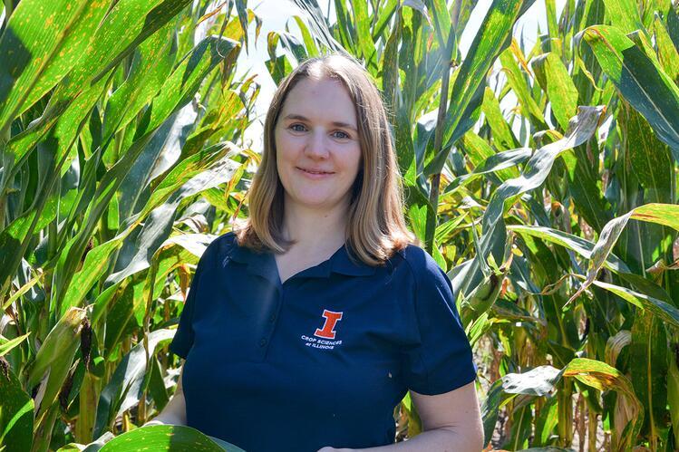 Tiffany Jamann standing among corn plants