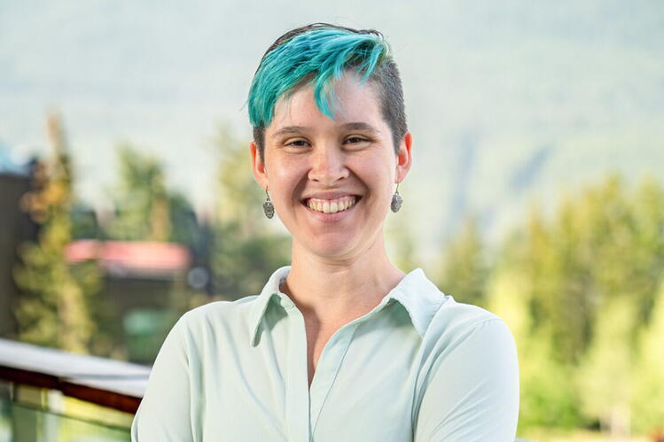 Hannah Heath standing in front of a blurred background outdoors