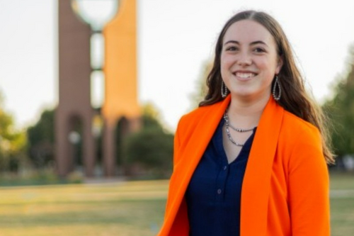 Dakoda Maguire standing in front of the bell tower for a headshot.