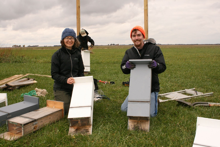 Joy O'Keefe (left) and Reed Crawford (right) with bat boxes installed for a previous study. 