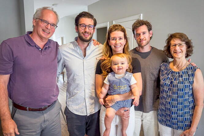 Five adults and a baby smile.