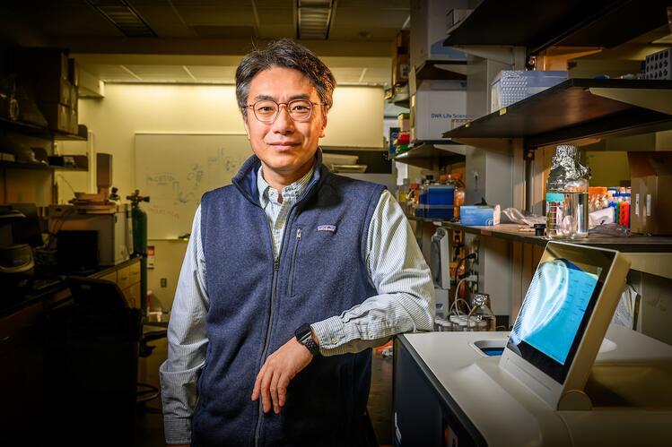 Yong-Su Jin pictured with benchtop equipment in a laboratory