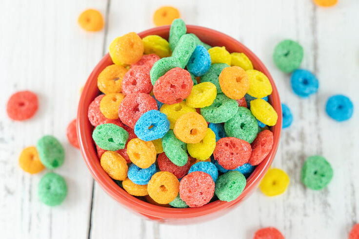 A bowl with multicolored cereal shown from above