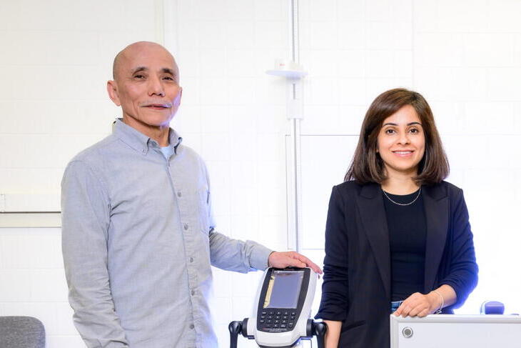 Manabu T. Nakamura (left) and Nouf W. Alfouzan A man in a blue shirt and a woman in a black jacket stand next to measuring equipment