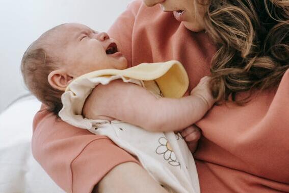 A mother holds her crying baby