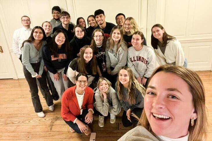 A large group of INI students pose for a picture.