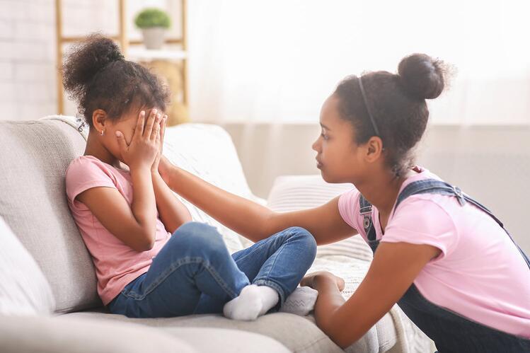 teen girl helping sibling