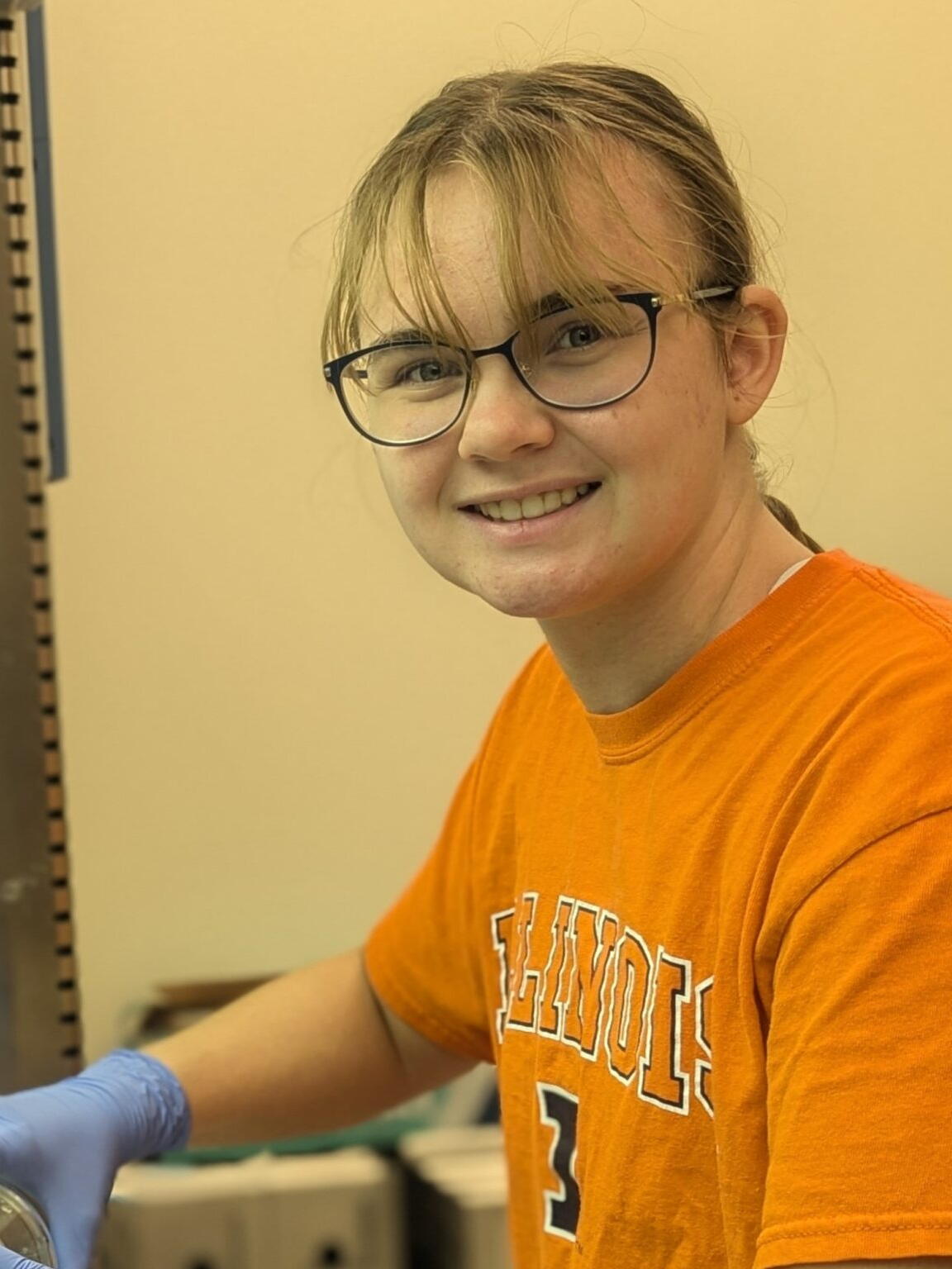 Allison Kokal smiles for the camera in an orange Illinois shirt