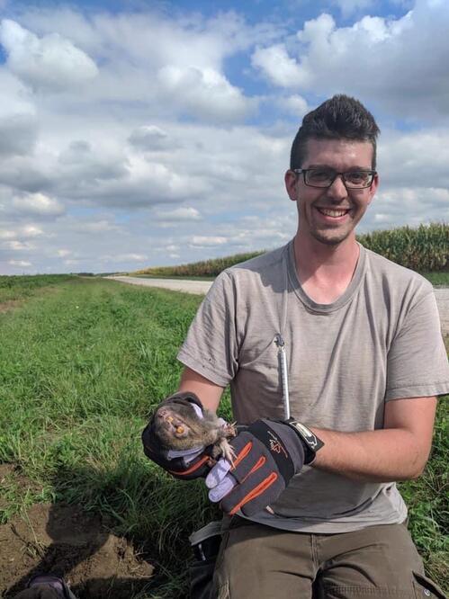 Author Nathan Alexander holding a pocket gopher