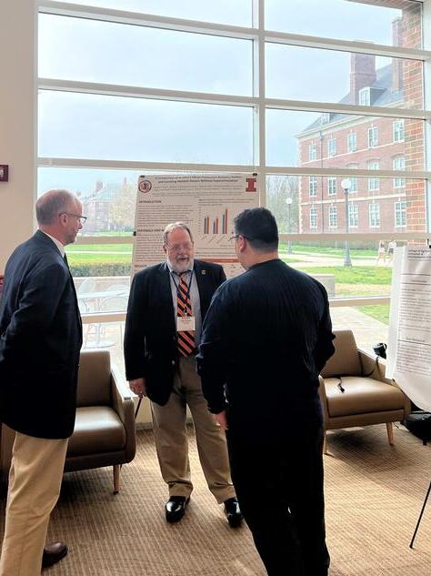 faculty and students at a poster session