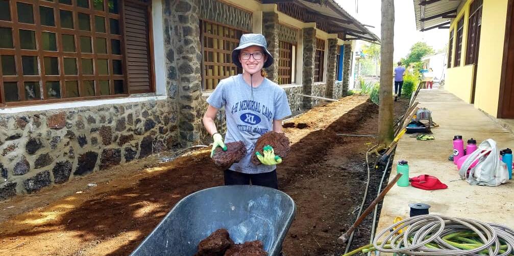 Study abroad student holding soil