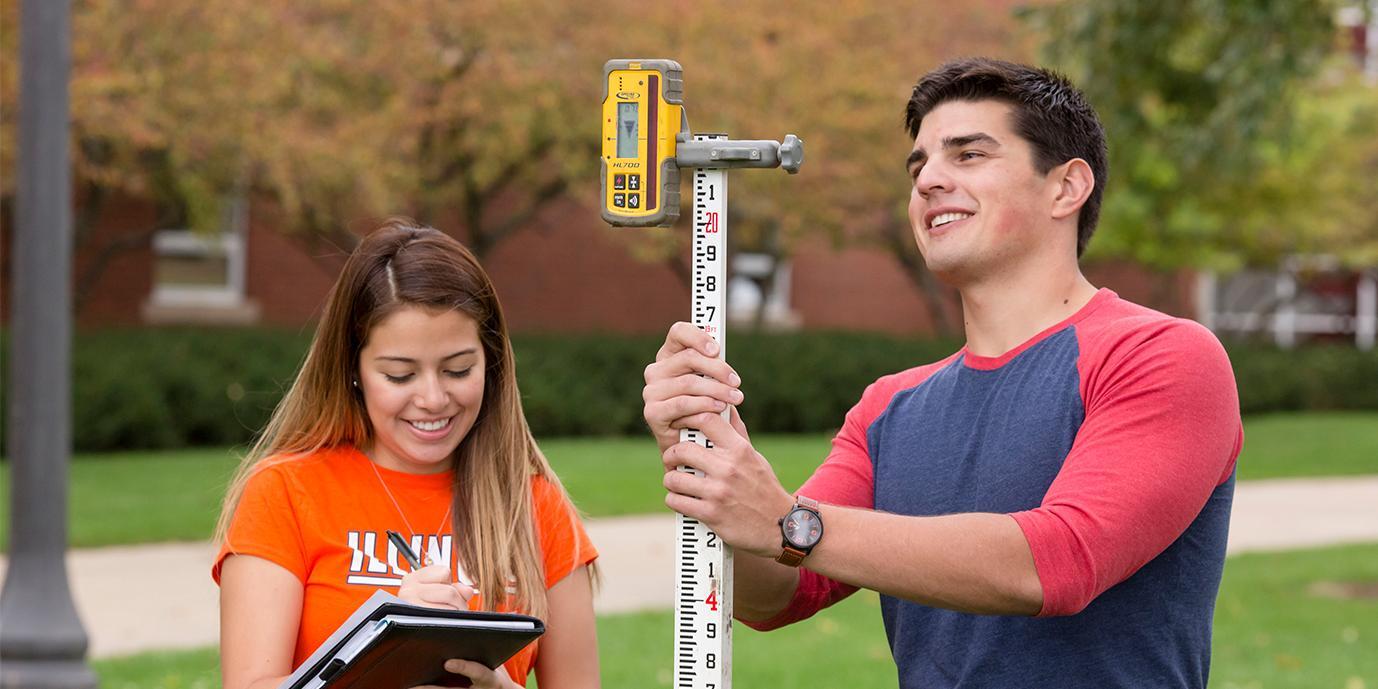Students working with land survey technology.