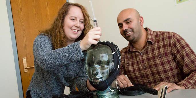 Students working on a bust